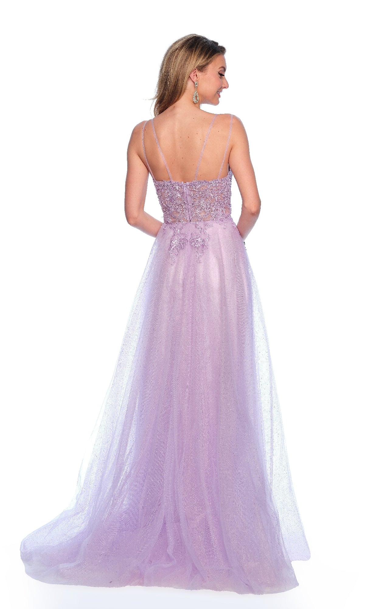 A woman faces away from the camera in the Long Lilac Prom Dress: Dave & Johnny 11686, a floor-length pastel purple gown with thin straps and lace detailing, set against a white background.